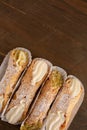 Top view of four delicious cannoli on wooden background Royalty Free Stock Photo