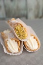 Top view of four delicious cannoli on wooden background Royalty Free Stock Photo