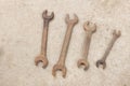 Top view four old rusted spanner wrenches Mechanic tool on grey concrete background