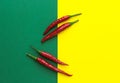 Top view, four red chili peppers on a yellow-green background Royalty Free Stock Photo