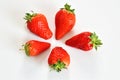 Top view of four strawberries on white plane Royalty Free Stock Photo