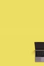 Top view fragment of modern laptop isolated on colored background. Copy space