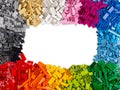 Top view of frame of many various colorful rainbow colored stackable plastic toy bricks with copy space isolated white background