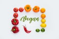 top view of frame of vegetables and fruits with word Vegan