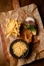 top view of french fries and bowl of sauerkraut and delicious batter fried pork ears Royalty Free Stock Photo