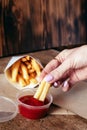 Top view of French fries. The concept of fast food, quick bites and restaurants for catering. Potatoes in carton and ketchup. Royalty Free Stock Photo