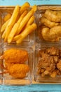 french fries and deep fried shrimps and chicken nuggets and popcorn chicken vertical composition Royalty Free Stock Photo