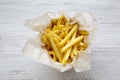 Top view, french fries over white wooden table.