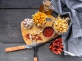 Top view french fries with tomato sauce and a portion of smoked sausages on a rustic background. Tasty Fast Food Snacks. Fork, Royalty Free Stock Photo