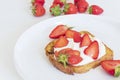 top view of french toasted topping with white cream and strawberries.