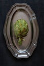 Top view of fresh artichoke green on metal dish