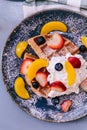 Top view of Fresh baked Pancakes topping with strawberry, orange, blueberry and whip cream Royalty Free Stock Photo