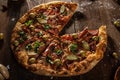 Top view of fresh baked pizza without slice served on wooden tab Royalty Free Stock Photo