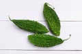 Top view fresh bitter gourd on white wooden board Royalty Free Stock Photo