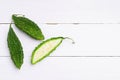 Top view fresh bitter gourd on white wooden board background Royalty Free Stock Photo