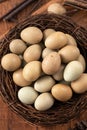 Fresh button quail eggs in a nest on wooden table background Royalty Free Stock Photo