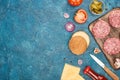 Top view of fresh cheeseburger ingredients on blue textured surface Royalty Free Stock Photo