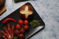 Top view of fresh cherry tomatoes with bacon rolls and bread on a kitchen table Royalty Free Stock Photo