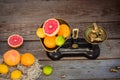 Top view Fresh citrus fruits in vintage scale and several oranges, lemons, grapefruit, lime on the old rustic wooden table with a Royalty Free Stock Photo