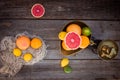 Top view Fresh citrus fruits in vintage scale and several oranges, lemons, grapefruit, lime on the old rustic wooden table with a Royalty Free Stock Photo