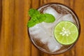 Top view of fresh cocktail with lime slice and mint on wood back Royalty Free Stock Photo