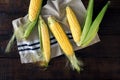 Fresh corn on cobs on dark wooden table Royalty Free Stock Photo