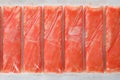 Top view on fresh crab sticks in pack as background, closeup Royalty Free Stock Photo