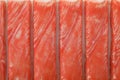 Top view on fresh crab sticks in pack as background, closeup Royalty Free Stock Photo