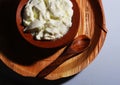 A top view of fresh curd on clay pot with palm tree leaf plate