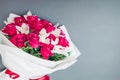 Top view of fresh flowers on grey background. Bouquet of red roses and white orchids. Present gift for holiday. Space Royalty Free Stock Photo