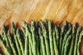 Top view of fresh green asparagus border on vintage wooden table. Cooking vegetarian food with organic ingredient on rustic board Royalty Free Stock Photo