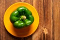 Fresh green bell pepper with drips on wood table Royalty Free Stock Photo