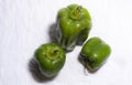 Top view of fresh green capsicums placed in a white copy space background.