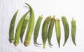 Top view of fresh green ladies fingers placed in a white copy space background.