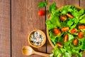 Top view of fresh green vegetable with red cherry tomato, onion and spinach with lettuce. Salad sesame dressing in wood bowl. Diet Royalty Free Stock Photo