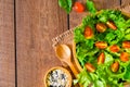 Top view of fresh green vegetable with red cherry tomato, onion and spinach with lettuce. Salad sesame dressing in wood bowl. Diet Royalty Free Stock Photo