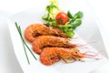 Top view of fresh grilled jumbo prawns with green salad.