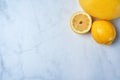 Top view of fresh lemons on kitchen marble. Antioxidant vitamin on white background