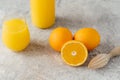 Top view of fresh oranges and fresh orange juice in glass, wooden juicer on white table. Multifruit juice. Fruit drink full of Royalty Free Stock Photo