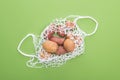 Top view of fresh potatoes in eco friendly string bag isolated on green. Royalty Free Stock Photo