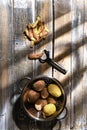 Top view of fresh potatoes and potato peelings with a knife on a table