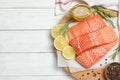 Top view of fresh raw salmon and products on wooden table, space for text. Fish delicacy Royalty Free Stock Photo