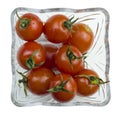 Top view of fresh red cherry tomatoes with a water drops in a glass bowl isolated on a white background Royalty Free Stock Photo