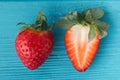 Top view of fresh red strawberries on the wooden turquoise background with a copy space for a free text. Summer berries textured Royalty Free Stock Photo