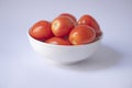 Tomato isolate. Tomatoes in a white bowl on white background. Royalty Free Stock Photo