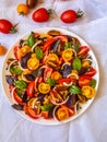 Top view of Fresh red & yellow cherry tomato salad and green and red basil leaves Royalty Free Stock Photo