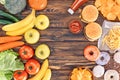 top view of fresh ripe fruits with vegetables and assorted junk food on wooden Royalty Free Stock Photo