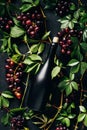 top view of fresh ripe grapes green leaves and bottle of wine on black Royalty Free Stock Photo