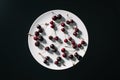 top view of fresh ripe red cherries on round white plate Royalty Free Stock Photo