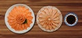 Top view of fresh salmon and grill sashimi and shoyu serve on flower shape in white ice bowl boat isolated on wood background, Ja Royalty Free Stock Photo